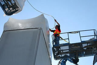 A worker using a heat torch on Liberty Industrial Shrink Film