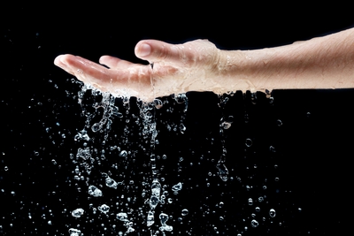 Water Falling on Hand